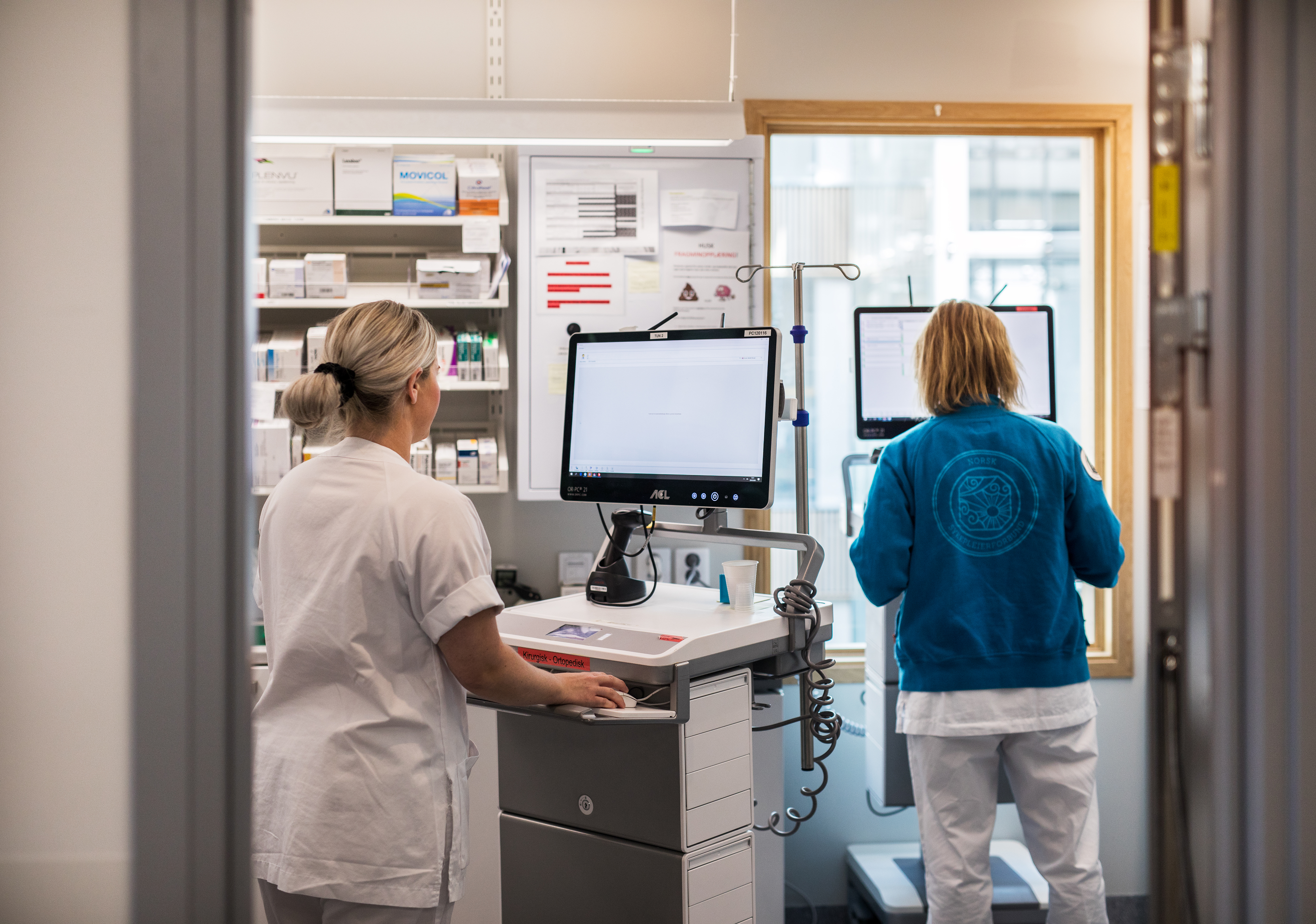 To kvinner kvar hver sin maskin på traller